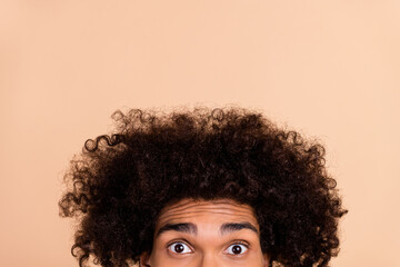 Cropped view portrait of attractive funky amazed stunned guy with chevelure staring isolated over beige pastel color background