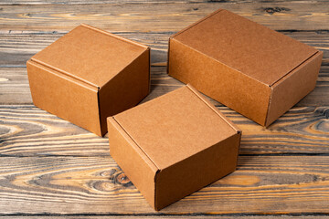 Wall Mural - Pile of cardboard boxes on wooden background