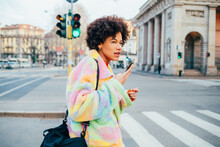 Young Black Woman Walking Outdoors Using Smartphone Sending Vocal Instant Message