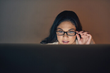 Poster - work hard for what you want. shot of a young businesswoman using a computer during a late night at w