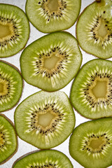 Wall Mural - Fresh organic kiwi fruit sliced. Green kiwi circles background. Line up. Kiwi pattern. Flay lay. Top view