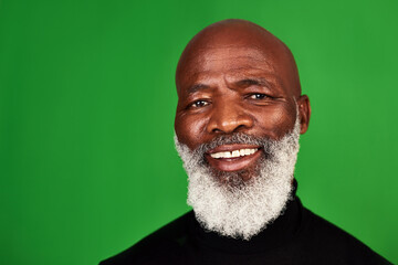 Poster - Its important to never stop smiling. Studio shot of a senior man posing against a green background.