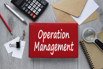 OPERATION MANAGEMENT. text on red notepad on wooden table