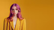 Portrait of a young girl with pink hair. Perfect hairstyle and hair coloring. Girl teenager on a yellow background. Freedom to express yourself
