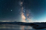 Fototapeta Zachód słońca - Beautiful night landscape. Bright milky way galaxy over the lake and mountains.