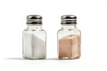 White Sea Salt And Pink Himalayan Salt In Salt Shakers Isolated On White Background, 

Clipping Path Included