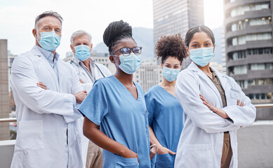 Poster - Theyre ready to tackle another day. Shot of a group of doctors standing with their arms crossed in the city.