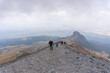 © Nailotl - Young adventurous backpackers hiking on a mountain top