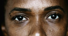 Close-up African Woman Eyes Macro Staring At Camera