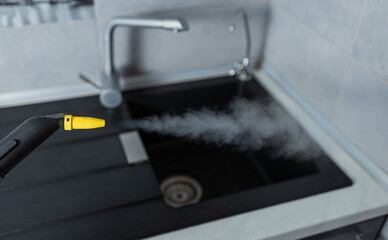 Wall Mural - Yellow steam cleaner. For cleaning Windows and furniture with steam.Steam under pressure