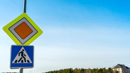 Road signs Main road and Crosswalk on blue sky background. Space for text. Traffic signs main road and pedestrian crossing.