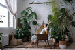 © DimaBerlin - Relaxed freelancer gardener enjoy spending time in home garden with laptop buying new house plant monstera for greenhouse in home office. Florist female entrepreneur with laptop stretching and smiling