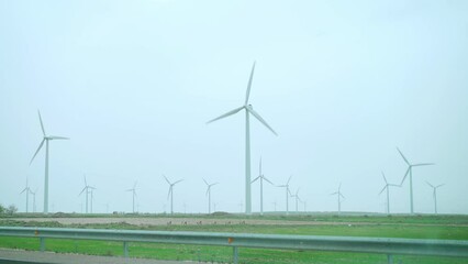 Wall Mural - Large wind turbines with blades in field blue sky wind park. Alternative energy