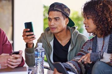 Poster - Any idea how this app works. A student using his phone while sitting with friends.