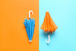 © Pixel-Shot - Two small umbrellas on color background