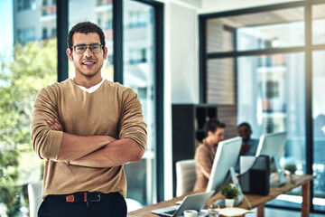 Poster - I smile a lot more nowadays, as an entrepreneur. Shot of a designer posing in the office with colleagues blurred in the background.