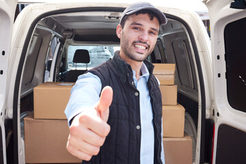 Aufkleber - Quality service is my promise to you. Portrait of a young delivery man showing thumbs up while loading boxes from a van.