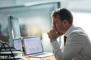 Fototapete - What am I going to do. Shot of a worried businessman sitting at his desk in the office.
