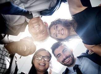 Aufkleber - great things happen when we put our heads together. low angle portrait of a team of happy colleagues