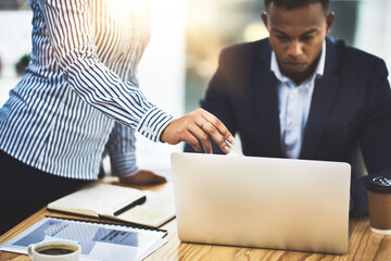 Fototapete - Searching online for some new ideas. Shot of two businesspeople working together on a laptop in an office.