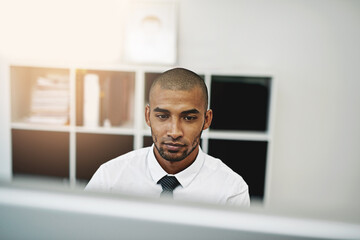 Aufkleber - He knows how far hard work will get him. Shot of a young businessman using a computer at work.