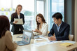 © Natee Meepian - Group of asian business meeting and discussing with new startup idea project. Creative business people planning strategy analysis and brainstorm with document report in office