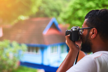 Wall Mural - He doesnt miss a moment. Shot of an unidentifiable tourist taking a picture from his balcony.