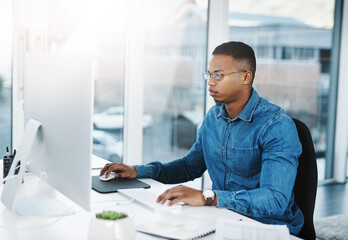 Poster - Luck is rare, working hard is always the best option. Shot of a young businessman working at his desk in a modern office.