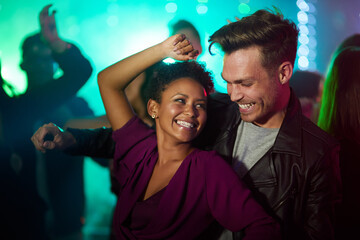 Poster - They only have eyes for each other in the club. Shot of a smiling young couple dancing together in a night club.