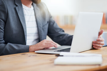 Poster - Its a matter of connectivity. Cropped shot of an unrecognizable businessman working on his laptop while sitting in the home office.