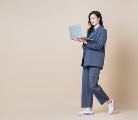 Wall Mural - Full length image of young Asian business woman on background