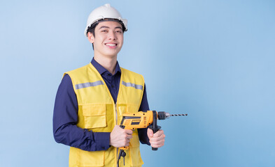 Wall Mural - Construction worker portrait on blue background