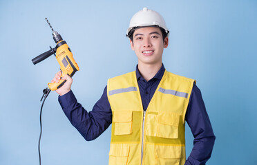 Wall Mural - Construction worker portrait on blue background