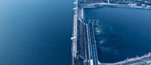 Aerial Top View Hydroelectric Dam, Water Discharge Through Locks, Blue Color Banner Industrial Concept