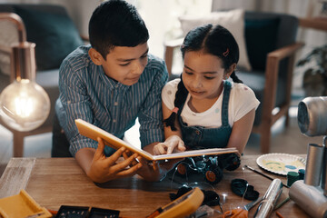 Wall Mural - Shes teaching me something new today. Shot of two adorable young siblings reading a book about robotics together at home.