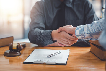 Wall Mural - Businessman handshake partner lawyers or attorneys discussing a contract agreement. Business people shaking hands to congratulate success.