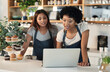 © Allistair F/peopleimages.com - Will you be able to work this shift next week. Shot of two young women working together on a laptop in a cafe.