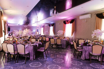 Hall decor for events, wedding decor, presidium and tables for guests with flowers, table decor elements