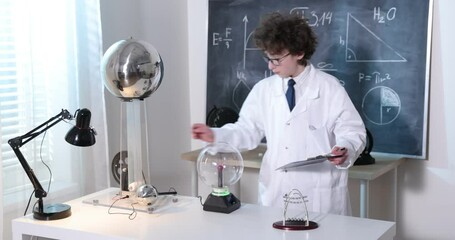 Wall Mural - schoolboy experimenting in physics class. young student doing physics experiment in the classroom