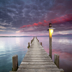 Wall Mural - romantic sunset on the jetty at lake