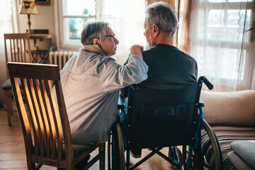 Sticker - Couple of two sad old people in love sitting together at home. Senior people healthcare love concept