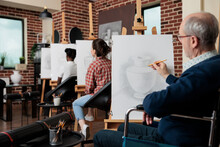 Senior Paralyzed Man In Wheelchair Attenting Art Class Drawing Vase Sketch On White Canvas Developing Sketching Skills For Personal Growth. Diverse Group Of People Creating Modern Artwork