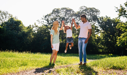 Wall Mural - happy multiethnic family having fun together outdoors. people love happiness concept