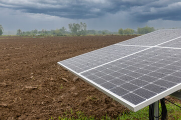 photovoltaic solar energy panels in farm on the rainy seasons. water raindrops on cell glass