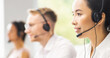 Team of professional support staff working in the office. Colleagues in the workplace solve customer problems. Call center and customer support concept.