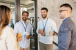 © Syda Productions - business, people and corporate concept - group of happy smiling colleagues with name tags drinking takeaway coffee at office