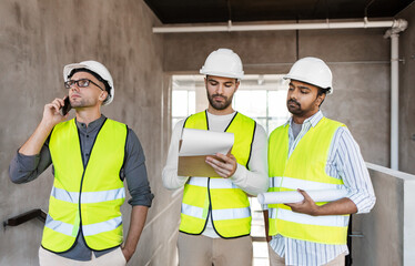 Sticker - architecture, construction business and people concept - male architects in helmets with smartphone, blueprint and clipboard working at office building