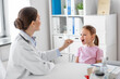 © Syda Productions - medicine, healthcare and pediatry concept - female doctor or pediatrician with tongue depressor checking little girl patient's throat on medical exam at clinic