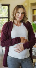 vertical video portrait of smiling pregnant caucasian expectant mother holding belly at home