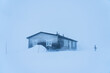 A mountain hut offering shelter from a severe snow storm (whiteout) in Swedish Lapland during winter.